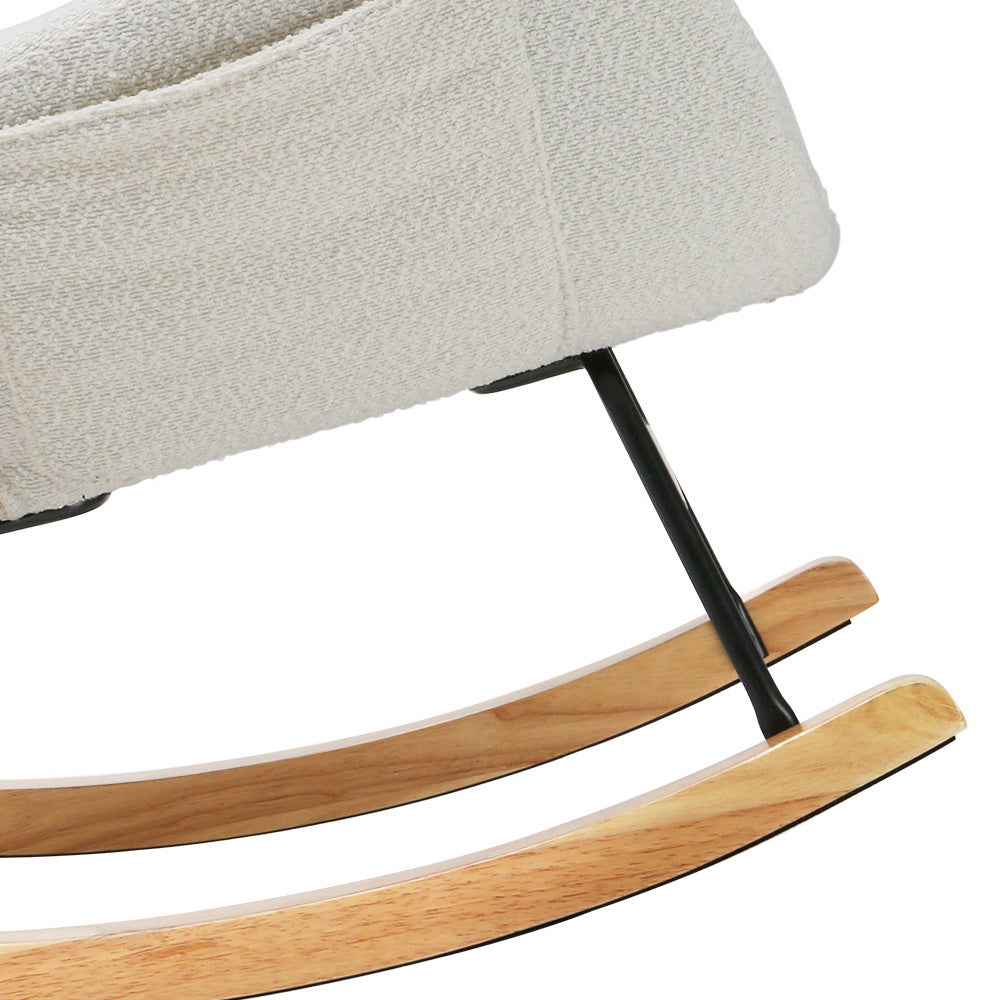 Close-up of white teddy rocking chair showing natural wood curved rocker runners and black metal frame legs