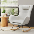 White teddy wingback rocking chair with headrest pillow and wood rocker runners in lifestyle room with side table and plants