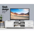 White TV unit 120cm sleek design in grey room with large TV disc player books on open shelves and remote