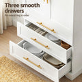 White pantry cabinet three open drawers with text 'Three smooth drawers' showing plates and utensils inside