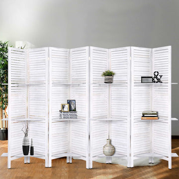 White-washed 6-panel louvered wood room divider with 3-tier shelves in grey lifestyle room with plant vases and books