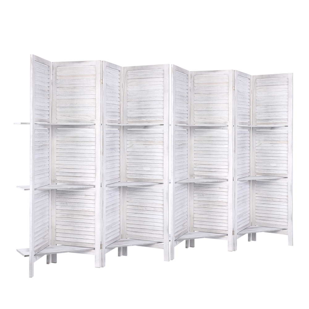 White-washed 8-panel louvered wood room divider with 3-tier shelves flat open front view on white background
