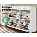 White wide shoe cabinet all four flip-out trays open loaded with heels and sneakers footwear paradise up to 36 pairs badge
