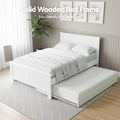 White solid wooden bed frame with trundle pulled out in bedroom, text Solid Wooden Bed Frame Eco-Friendly and Built to Last