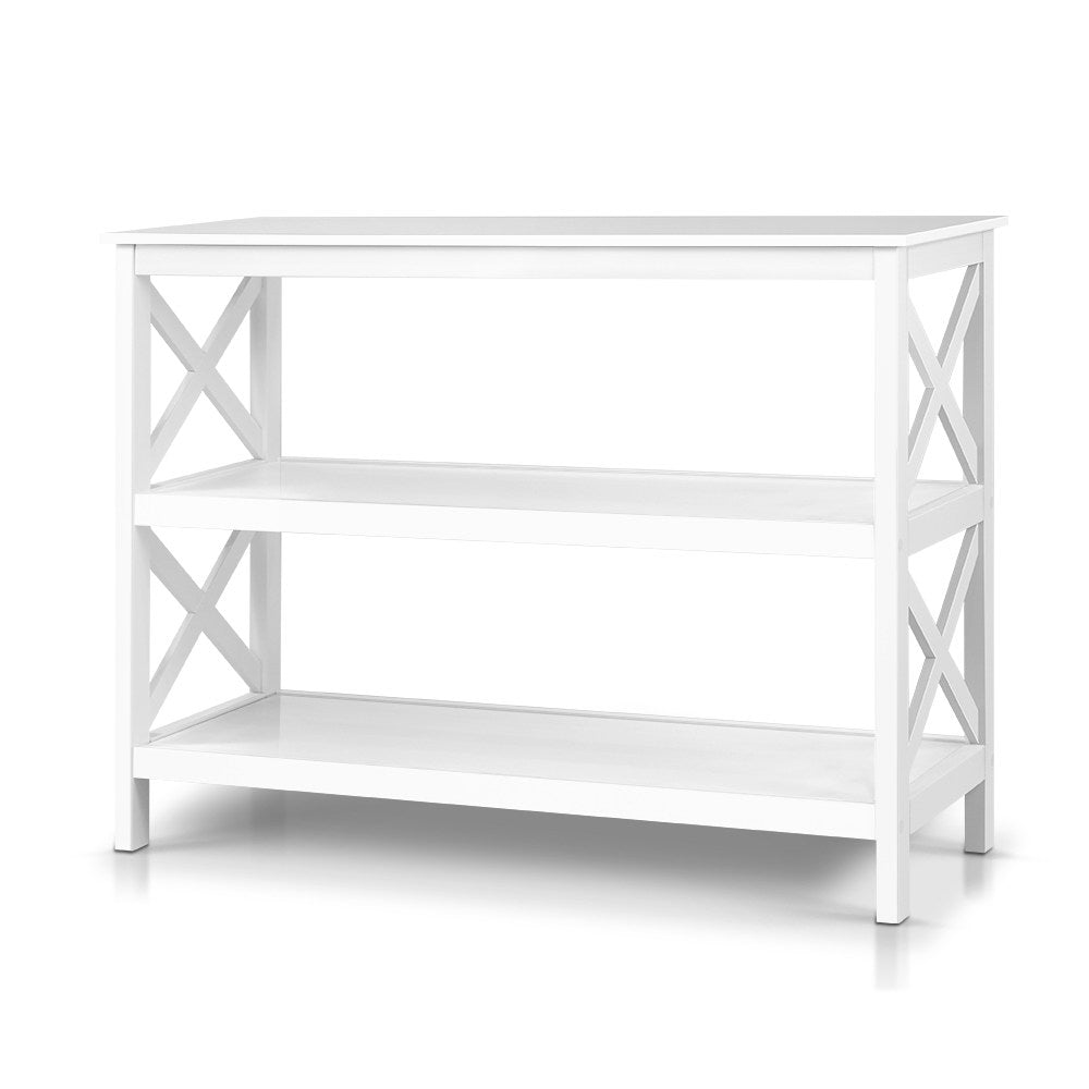 White console table with X-frame side panels and two open shelves, angle view on white background
