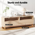 Natural wood TV unit in room with capacity labels 60kg top surface 10kg shelf and drawer with bust and lamp