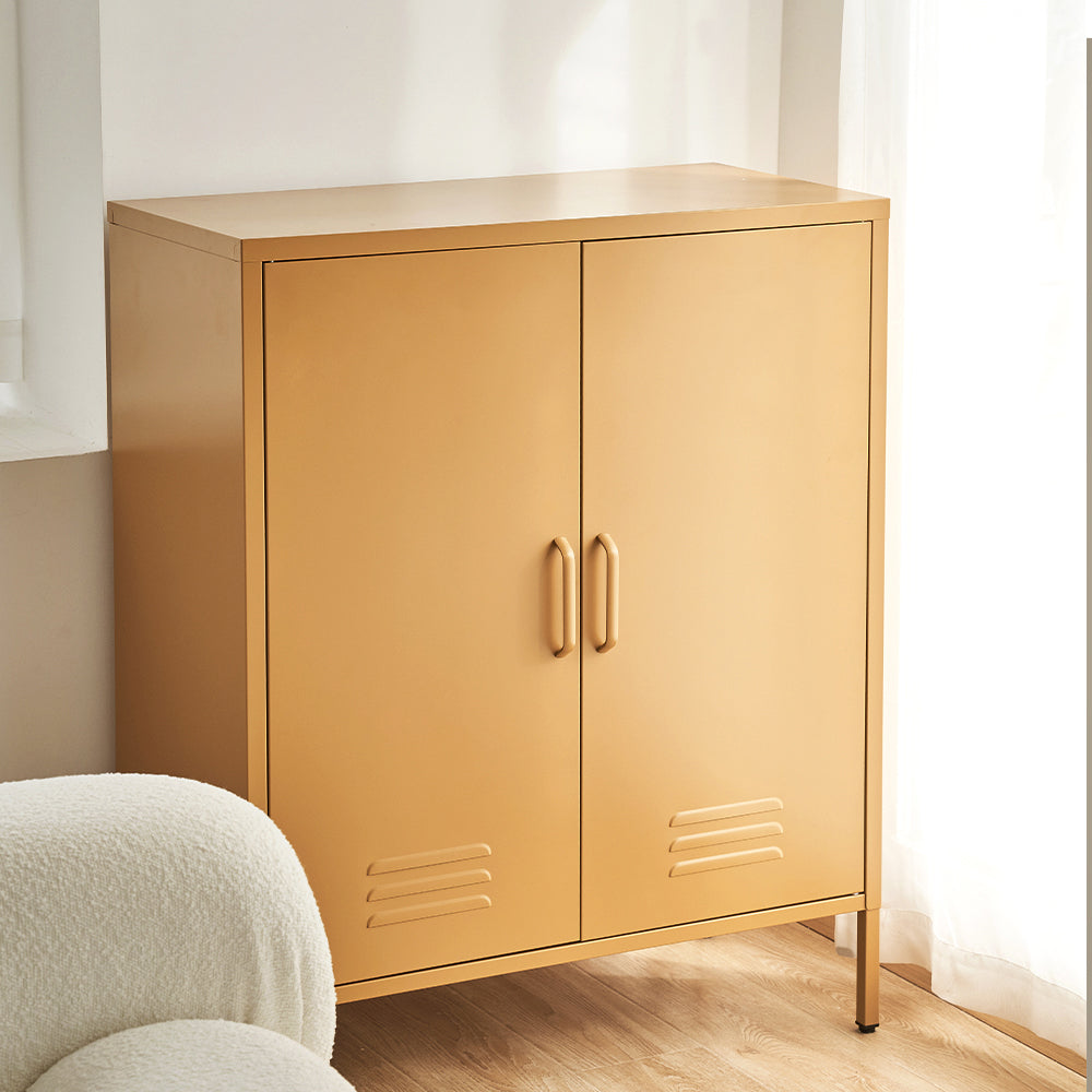 Mustard yellow two-door metal locker cabinet in room corner with boucle chair beside on wood floor
