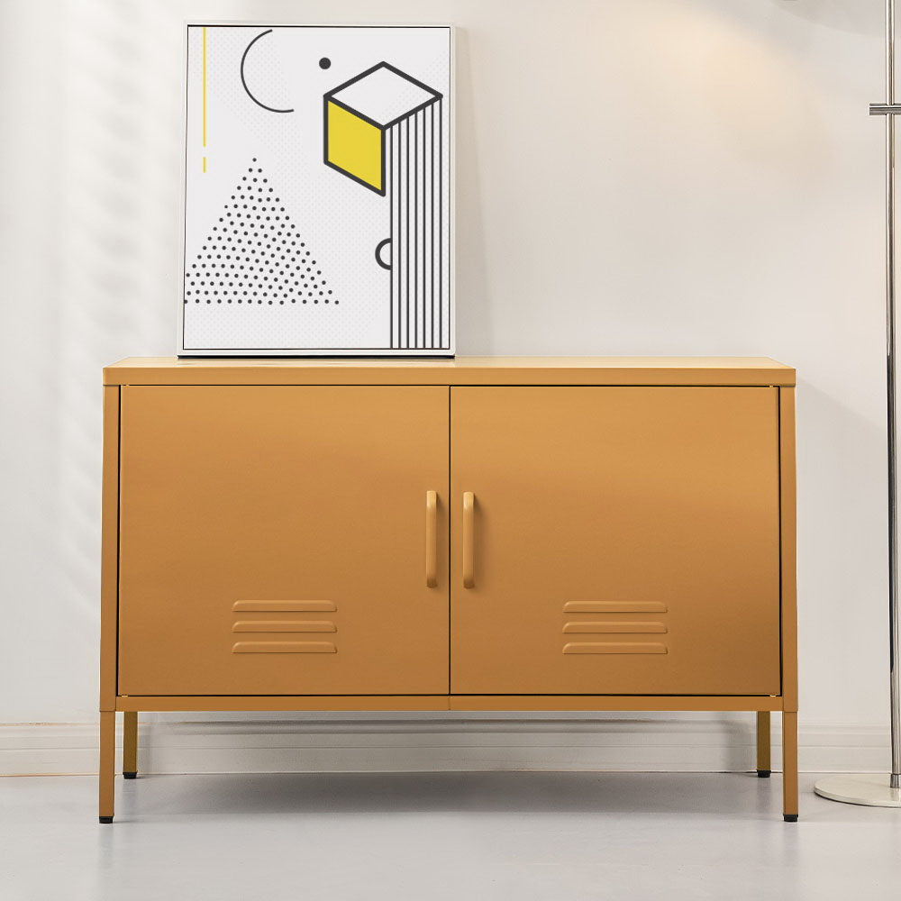 Mustard yellow two-door metal sideboard cabinet with louvre vents on grey floor, abstract art print on top